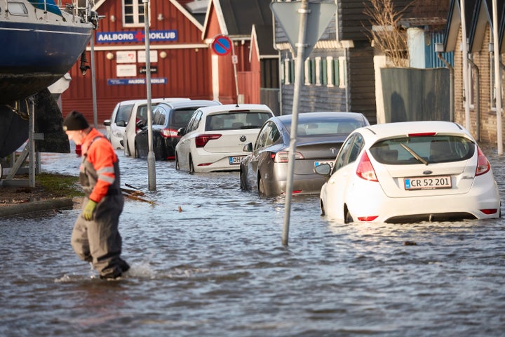 Cars stand in water on the Aalborg harbor front, North Jutland, Denmark, Friday Dec. 22, 2023.