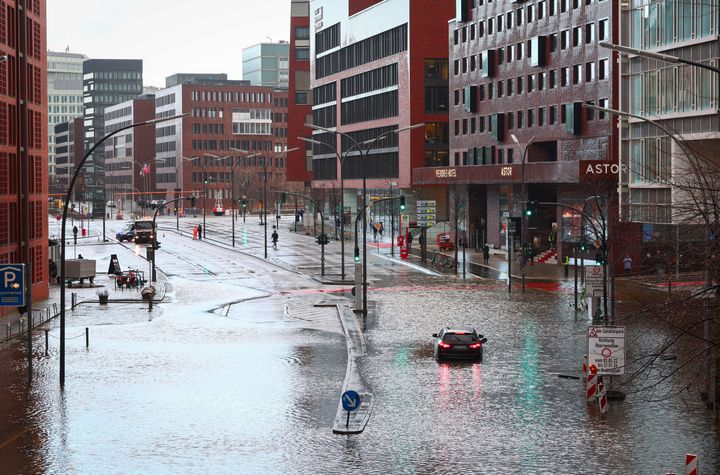 A stranded vehicle on the flooded street in Hafencity, Hamburg, Germany, Friday Dec. 22, 2023.