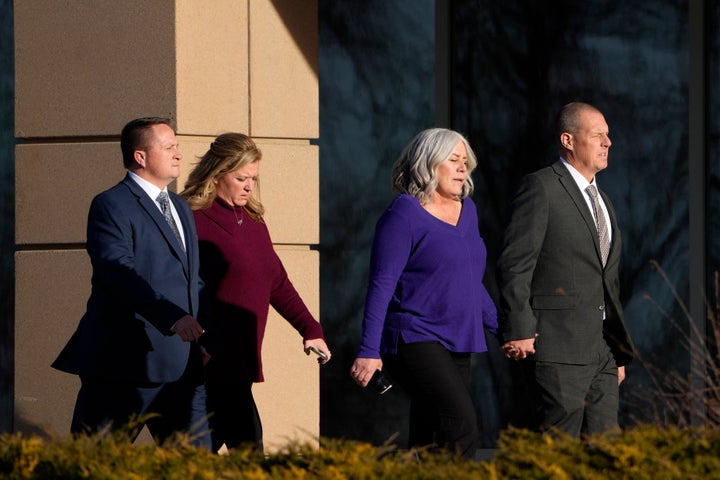 Paramedics Jeremy Cooper, far left, and Peter Cichuniec, far right, enter the Adams County, Colo., Justice Center, Friday, Dec. 22, 2023, in Brighton, Colo. (AP Photo/David Zalubowski)