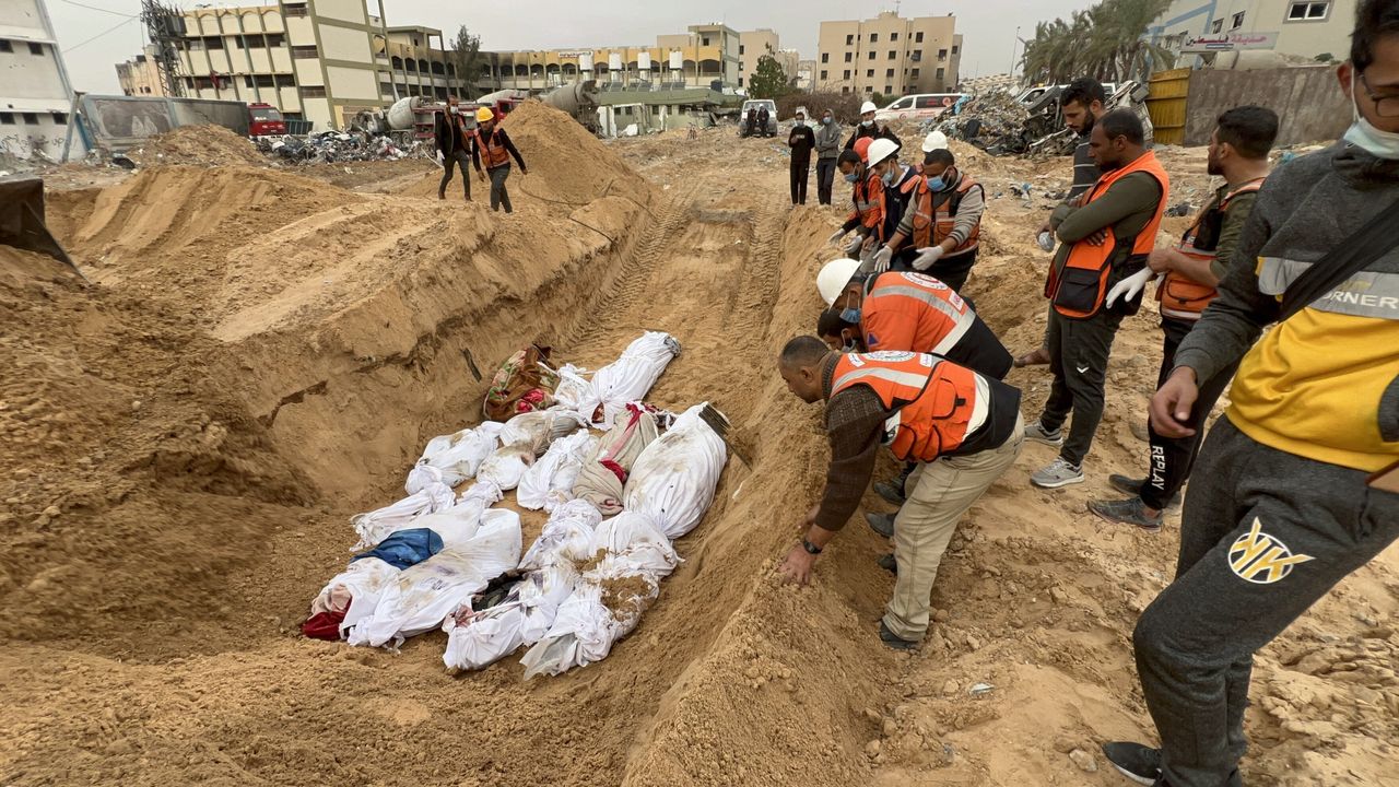 Palestinians killed in Israeli attacks are buried in a mass grave as some cemeteries run out of space due to the rising death toll as Israeli attacks continue in Gaza City, Gaza, on Dec. 23.