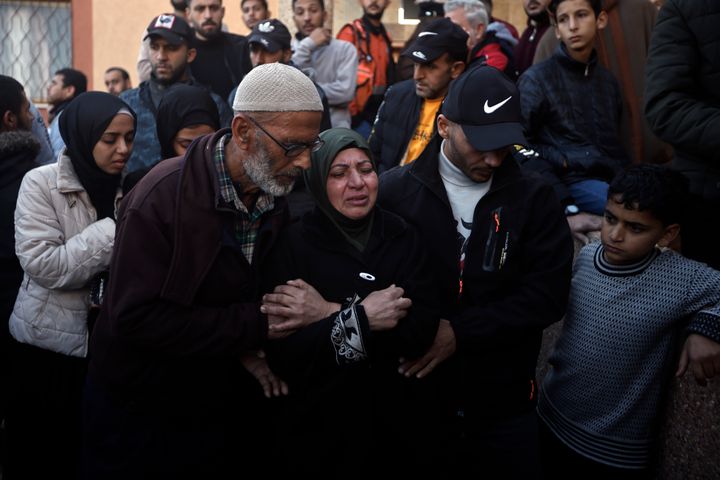 Palestinians mourn relatives killed in the Israeli bombardment of the Gaza Strip outside a morgue in Khan Younis on Sunday, Dec. 24, 2023. (AP Photo/Mohammed Dahman)