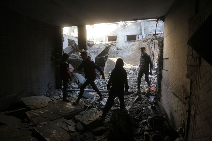 Palestinians look at the destruction after an Israeli strike in Rafah, Gaza Strip, Sunday, Dec. 24, 2023. (AP Photo/Hatem Ali)