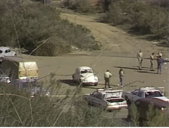 San Diego law enforcement investigators examine the area where Cara Knott's white Volkswagen Beetle (center) was found on Dec. 28, 1986.