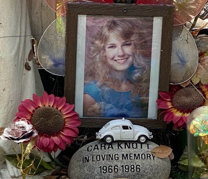 A memorial to Cara Knott sits at the base of an oak tree that her father planted decades ago in what is now known as the Crime Victims Memorial Oak Garden in San Diego, Dec. 24, 2023.