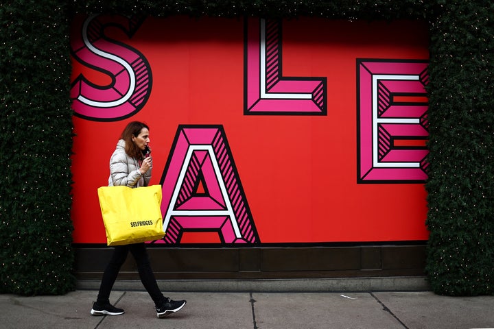 Shoppers carry shopping bags along Oxford Street during the Boxing Day sales in London on December 26, 2023. (Photo by HENRY NICHOLLS / AFP) (Photo by HENRY NICHOLLS/AFP via Getty Images)