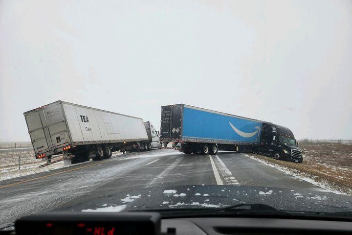 In this photo provided by Nebraska State Patrol, two tractor-trailers lose control on Christmas Day on Interstate 80 in Nebraska as a winter storm pummels part of the Midwest, on Monday, Dec. 25, 2023.