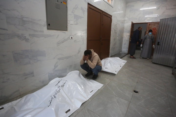 A Palestinian mourns relatives killed in the Israeli bombardment of the Gaza Strip in Khan Younis, Tuesday, Dec. 26, 2023. (AP Photo/Hatem Ali)