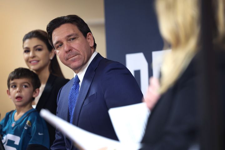 Florida Gov. Ron DeSantis (R), with his family by his side, speaks to guests during the Scott County Fireside Chat at the Tanglewood Hills Pavilion on Dec. 18 in Bettendorf, Iowa.
