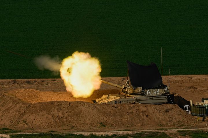 An Israeli mobile artillery unit fires a shell from southern Israel towards the Gaza Strip, in a position near the Israel-Gaza border on Sunday, Dec. 31, 2023. (AP Photo/Ohad Zwigenberg)