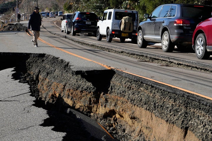 A traffic jam is seen on a partially collapsed road caused by powerful earthquake near Anamizu Town