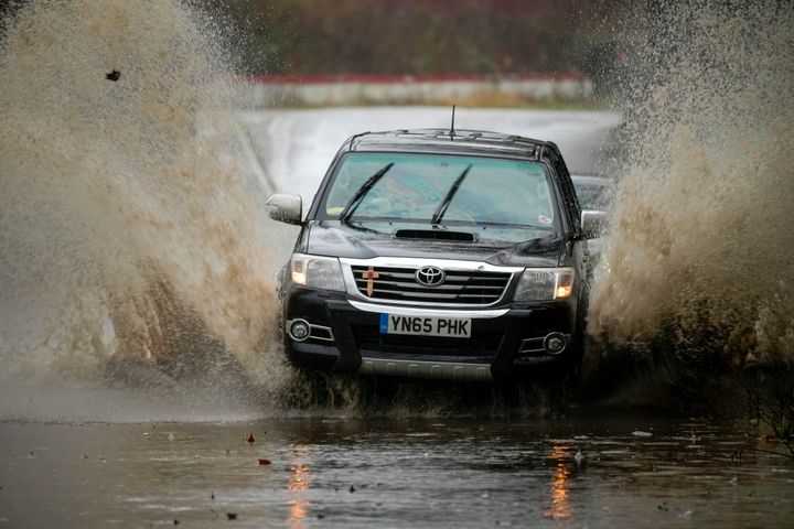 Motorists tackle a flooded road on January 02, 2024 in Ironbridge, England.