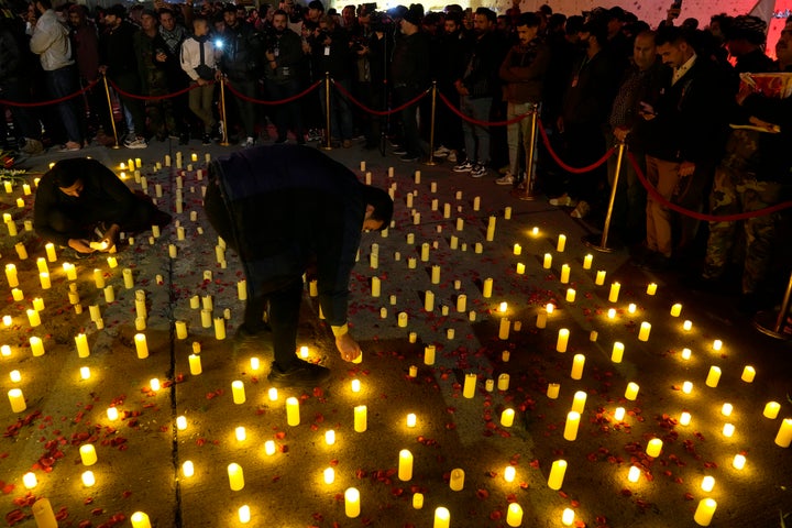 Iraqis light candles during mark the fourth anniversary of the deaths of Abu Mahdi al-Muhandis, deputy chief of the Popular Mobilization Forces (PMF), and General Qassem Soleimani, head of Iran's elite Quds force, at the spot where they were killed, near Baghdad's International Airport, in Baghdad, Iraq, Tuesday, Jan.2, 2024. Al-Muhandis and Soleimani were killed in an US air strike in Baghdad in 2020. (AP Photo/Hadi Mizban)