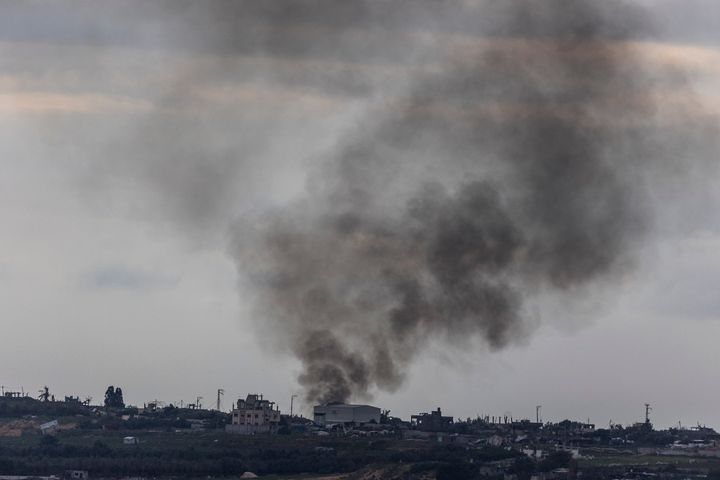 03 January 2024, Israel, Erez Crossing Point: A cloud of smoke rises over the destroyed buildings in Gaza.