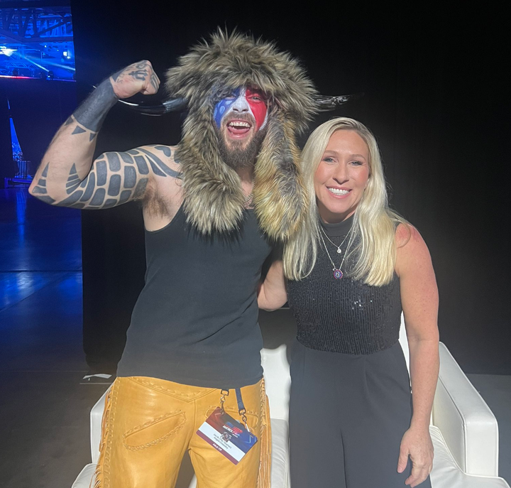 Rep. Marjorie Taylor Greene (R-Ga.), right, recently met with so-called QAnon Shaman Jacob Chansley, lamenting that the prominent Capitol riot participant had been treated "horrendously" by the government.