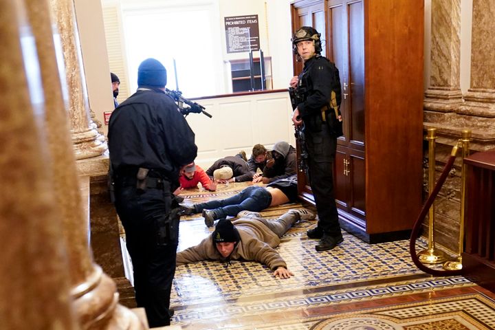 U.S. Capitol Police hold rioters at gunpoint near the House Chamber inside the Capitol on Jan. 6, 2021, in Washington.