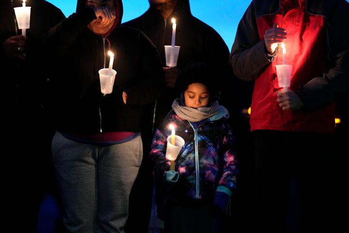 Local residents pray during a candlelight vigil following a shooting at Perry High School, Thursday, Jan. 4, 2024, in Perry, Iowa. (AP Photo/Charlie Neibergall)