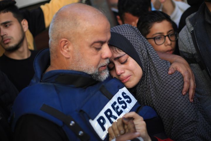 Wael Dahdouh, Al Jazeera bureau chief in Gaza, comforts his daughter as they mourn over the body of his dead son Hamza, who also worked as a journalist for Al Jazeera and was killed in an Israeli air strike on Rafah. Dahdouh has previously lost his wife, two other children and a grandson, and was injured himself during the war.