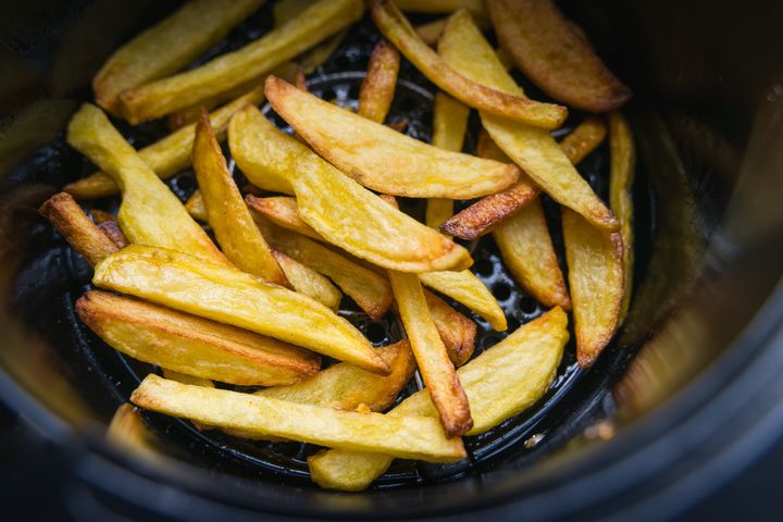 Close up on a bunch of crispy french-fried potatoes just cooked in the air frier