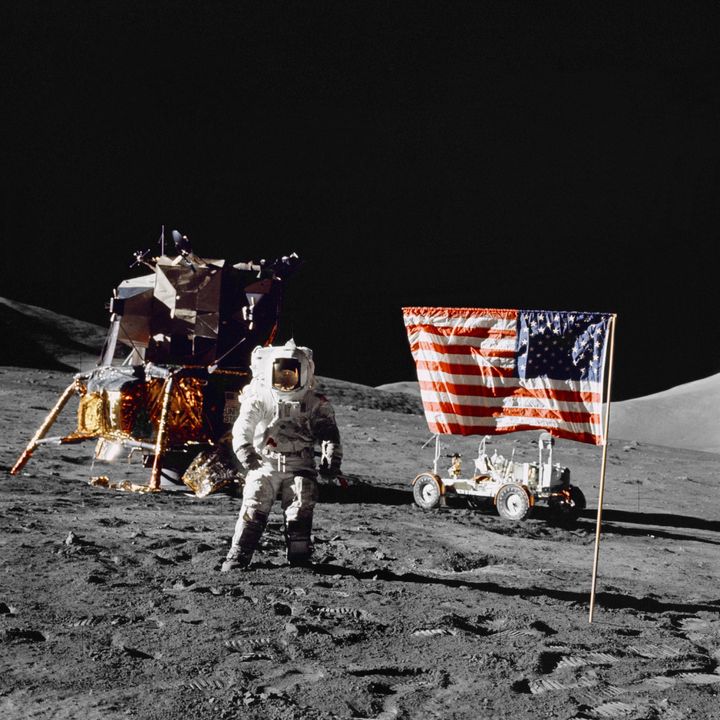 Harrison H Schmitt, pilot of the lunar module, stands on the lunar surface near the United States flag during NASA's final lunar landing mission in the Apollo series 13 December 1972.