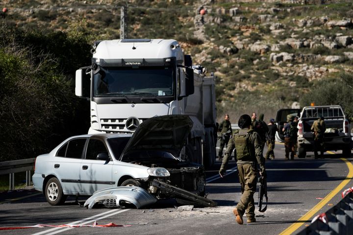 Israeli security forces examine the scene of a shooting attack, near Wadi al-Haramiya, West Bank, Sunday, Jan. 7, 2024. Israeli forces killed a young Palestinian girl while shooting at two people who rammed their car into a checkpoint, as the occupied territory continues to see a surge in deadly military raids and settler violence.