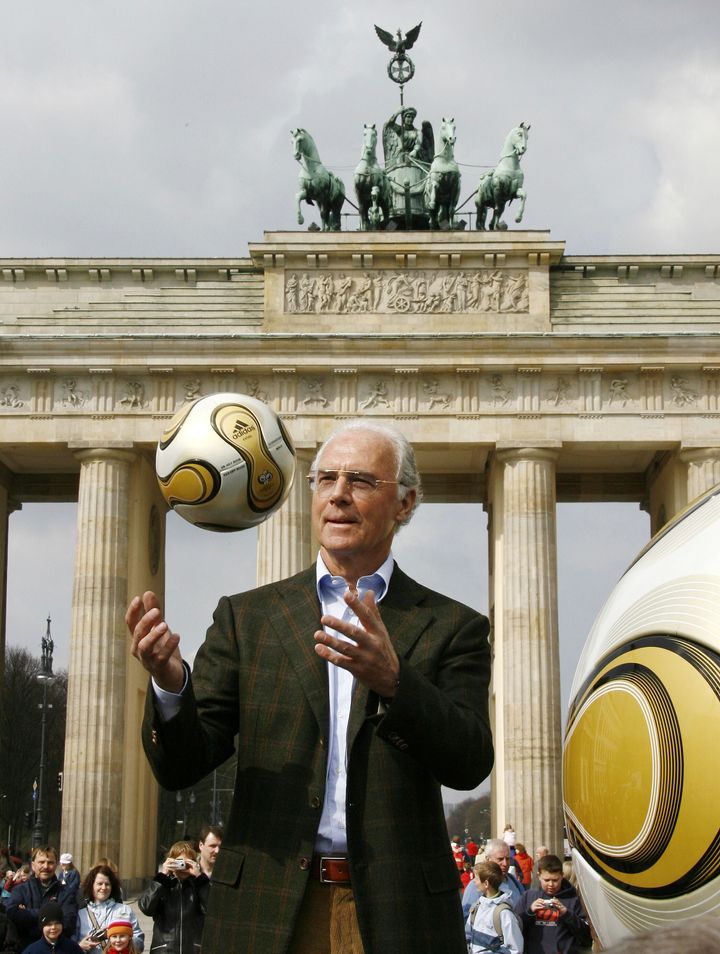 German soccer legend Franz Beckenbauer, head of Germany's organising committee for the soccer World Cup, plays with the Golden Ball for the World Cup in front of the Brandenburg Gate in Berlin, on April 18, 2006. 