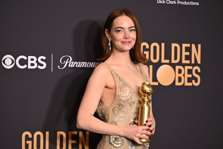 Emma Stone poses with her award for Best Performance by a Female Actor in a Motion Picture - Musical or Comedy for "Poor Things" at the 2023 Golden Globe Awards.