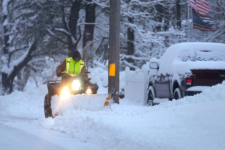 A man plows a snow covered driveway, on Jan. 7, 2024, in Derry, N.H. Some areas of New England are expected to receive about a foot of snow from a winter storm. 