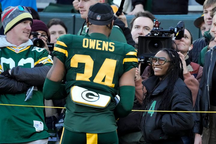 Green Bay Packers player Jonathan Owens talks to Olympic gold medalist Simone Biles prior to an NFL game on Nov. 19 in Green Bay, Wisconsin.