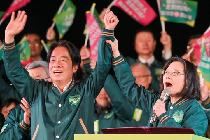 Taiwan's President Tsai Ing-wen joins hands with the presidential candidate of ruling Democratic Progressive Party Lai Ching-te during a campaign rally ahead of Taiwan's presidential elections in Taipei on Jan. 11.