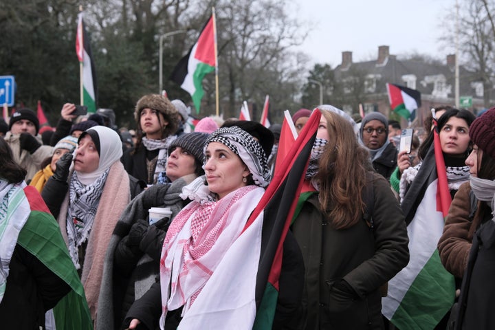 Protestors watch proceedings of a hearing on a giant video screen during a demonstration outside the International Court of Justice in The Hague, Netherlands, Thursday, Jan. 11, 2024. The United Nations' top court opens hearings Thursday into South Africa's allegation that Israel's bombardment of Gaza amounts to genocide against Palestinians, a claim that Israel strongly denies.