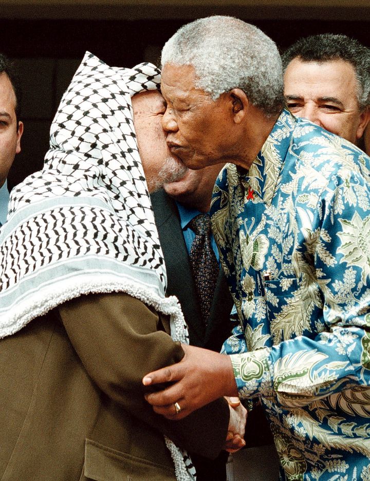 Palestinian leader Yasser Arafat and Nelson Mandela embrace at Mandela's home in Johannesburg, South Africa, on Jan. 13, 1990.