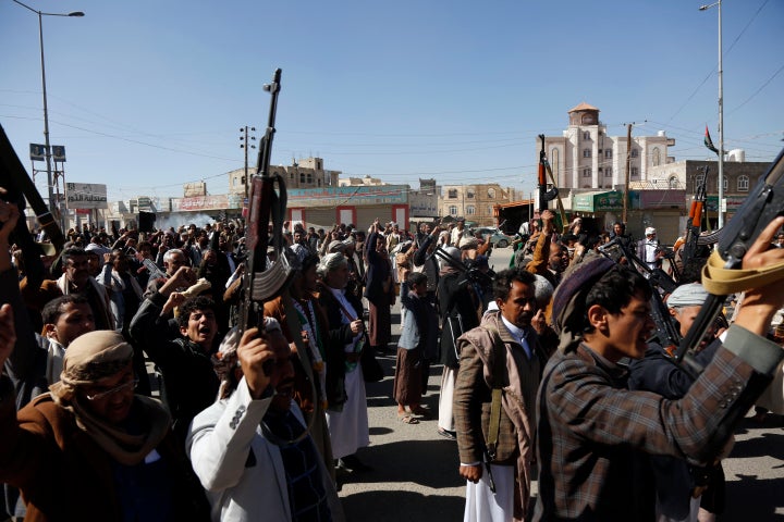 Yemeni protestors loyal to the Houthi movement lift their rifles as they participate in a protest held against Israel's ongoing war on Gaza