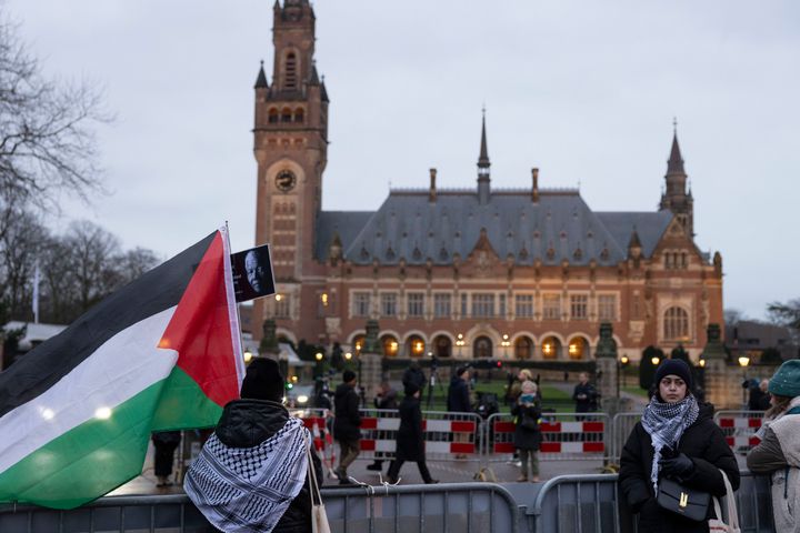 THE HAGUE, NETHERLANDS - JANUARY 11: Pro-Palestinian protesters stand in front of the International Court of Justice where a second day of hearings take place after South Africa has requested the International Criminal Court to indicate measures concerning alleged violations of human rights by Israel in the Gaza Strip on January 12, 2024 in The Hague, Netherlands. (Photo by Michel Porro/Getty Images)