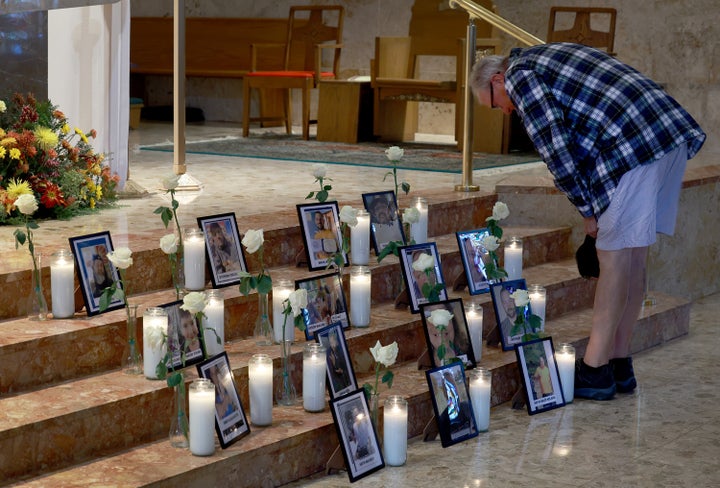 Tim Conrad looks on at a picture of his son, Thomas “Tommy” Conrad, during a memorial for those killed in the shooting in Lewiston, Maine. Tommy was the manager at the Just-In-Time Recreation when Robert Card opened fire, killing 18 people in two separate locations.