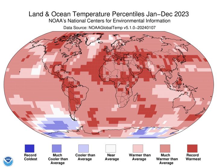 A world map plotted with color blocks depicting percentiles of global average land and ocean temperatures for the full year 2023. Color blocks depict increasing warmth, from dark blue (record-coldest area) to dark red (record-warmest area) and spanning areas in between that were "much cooler than average" through "much warmer than average."