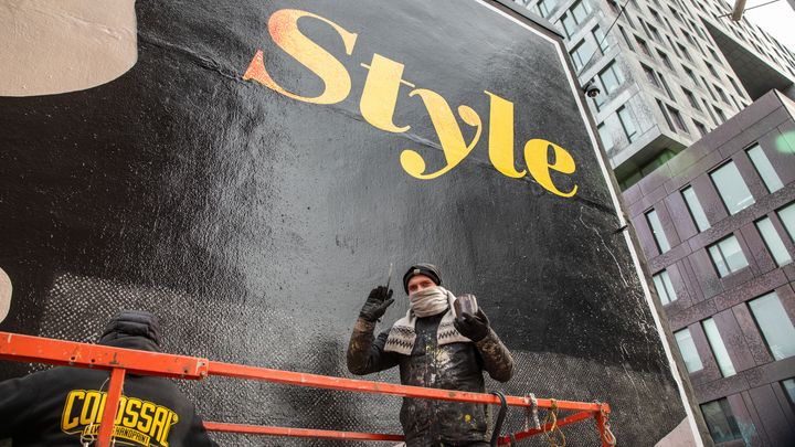 Colossal Media painter Harrison Cencer, paints an advertisement mural in New York City.