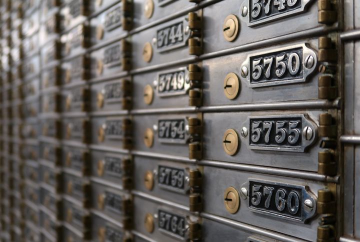 A bank of shut safety deposit boxes as seen from a side angle.