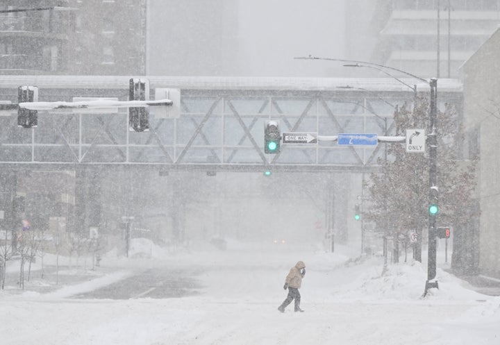 DES MOINES, IA - JANUARY 12: A pedestrian crosses the street during blizzard conditions ahead of the Iowa Caucuses on January 12, 2024 in Des Moines, IA. (Photo by Ricky Carioti/The Washington Post via Getty Images)