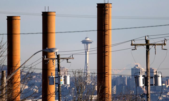 In this Thursday, Feb. 25, 2016, photo the Space Needle is seen in view of still standing but now defunct stacks at the Nucor Steel plant in Seattle. 