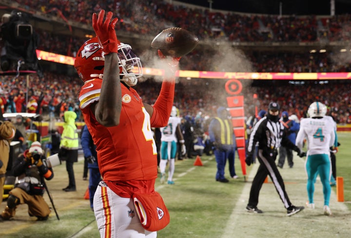 KANSAS CITY, MISSOURI - JANUARY 13: Rashee Rice #4 of the Kansas City Chiefs celebrates scoring a touchdown during the first quarter against the Miami Dolphins in the AFC Wild Card Playoffs at GEHA Field at Arrowhead Stadium on January 13, 2024 in Kansas City, Missouri. (Photo by Jamie Squire/Getty Images)