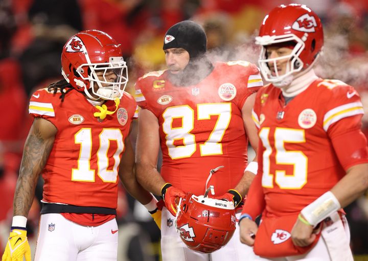 KANSAS CITY, MISSOURI - JANUARY 13: (L-R) Isiah Pacheco #10, Travis Kelce #87 and Patrick Mahomes #15 of the Kansas City Chiefs stand on the field before the AFC Wild Card Playoffs against the Miami Dolphins at GEHA Field at Arrowhead Stadium on January 13, 2024 in Kansas City, Missouri. (Photo by Jamie Squire/Getty Images)