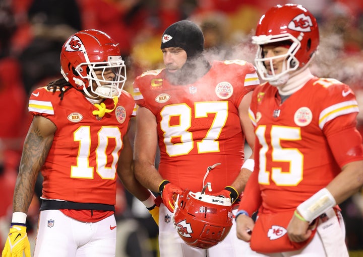 KANSAS CITY, MISSOURI - JANUARY 13: (L-R) Isiah Pacheco #10, Travis Kelce #87 and Patrick Mahomes #15 of the Kansas City Chiefs stand on the field before the AFC Wild Card Playoffs against the Miami Dolphins at GEHA Field at Arrowhead Stadium on January 13, 2024 in Kansas City, Missouri. (Photo by Jamie Squire/Getty Images)