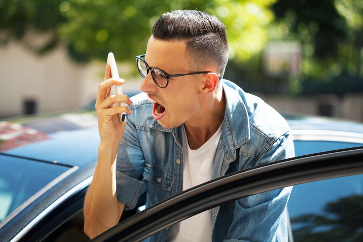 Angry young man talking on the phone