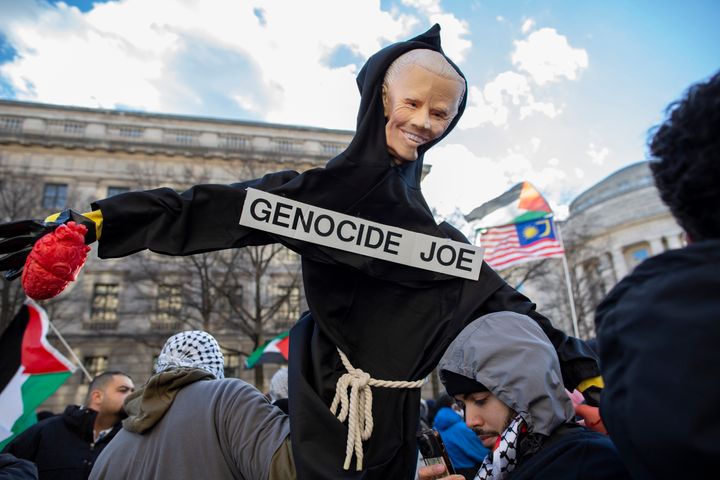 A demonstrator holds a sign with "Genocide Joe" written on it while joining in protest in Washington, D.C., on Jan. 13, 2024. Thousands of Pro-Palestinian demonstrators gathered at Freedom Plaza before marching to the White House with Palestinian flags and banners to call for a ceasefire in Gaza.