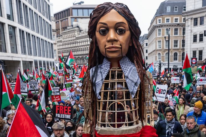 Little Amal, a 12-foot puppet of a 10-year-old Syrian refugee child, joins tens of thousands of pro-Palestinian protesters taking part in a Global Day of Action to call for an immediate ceasefire in Gaza on Jan. 13, 2024, in London, United Kingdom.