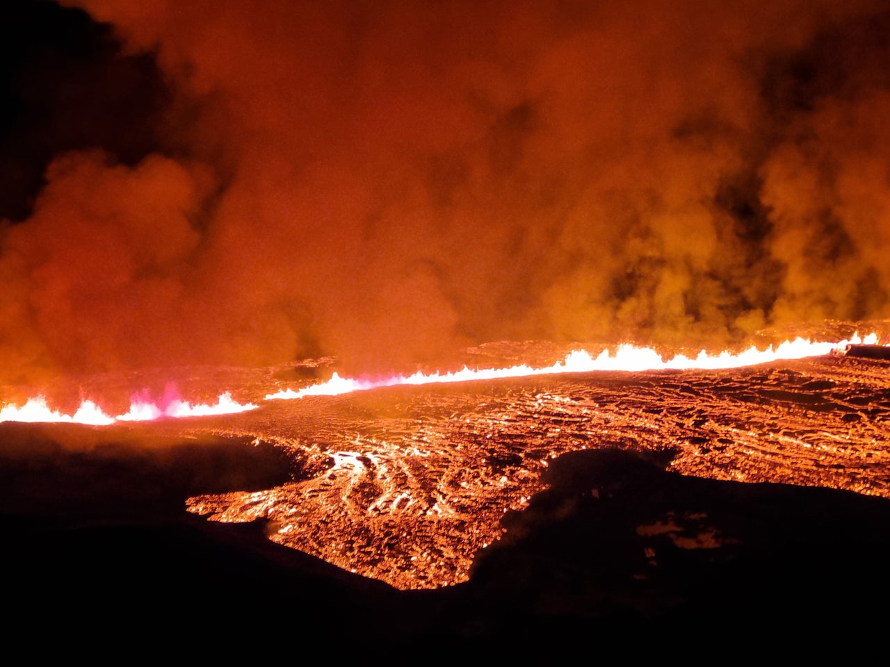 In this handout photo provided by the Iceland Coast Guard, lava is seen spewing from a volcano on Iceland's Reykjanes Peninsula.