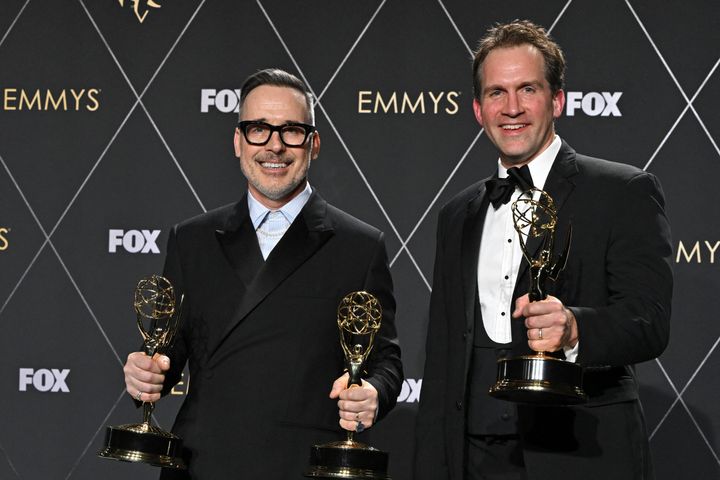 David Furnish and Luke Lloyd-Davies pose backstage at the Emmys following Sir Elton's win