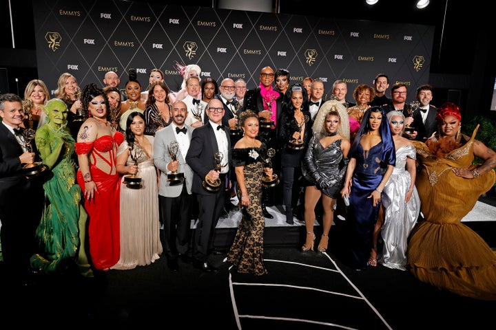 The cast and crew of Drag Race pictured behind the scenes at the Emmys after the show's win