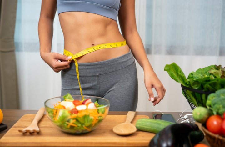 Woman measuring her waist