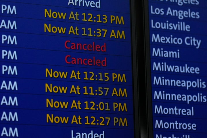 Canceled flights are illuminated on an electronic arrival board in Denver International Airport on Tuesday, Jan. 16, 2024. (AP Photo/David Zalubowski)
